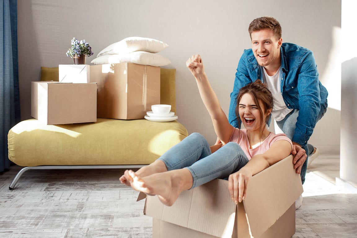 Young Family Couple Happily Moving into First  Apartment